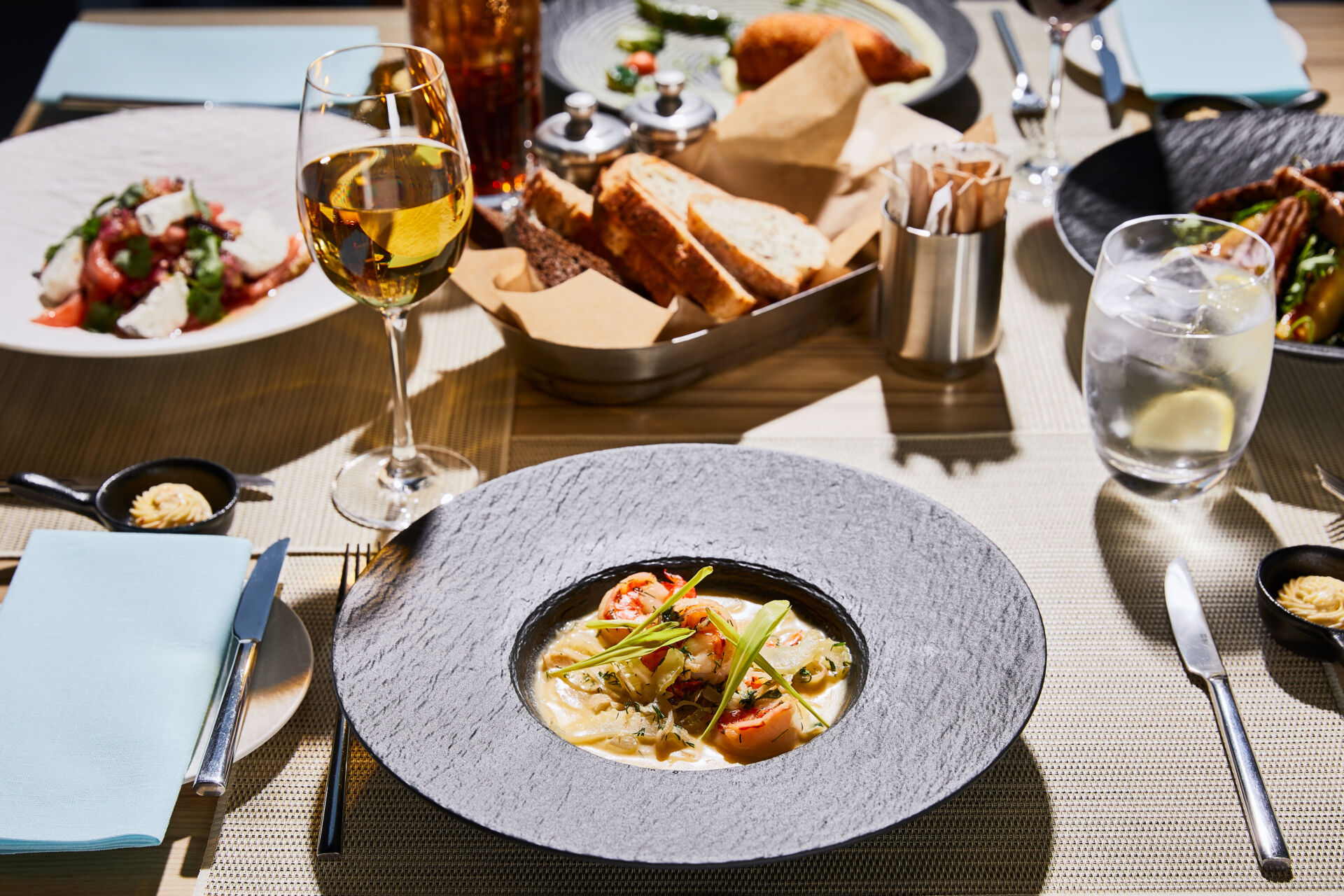 delicious soup with shrimps served on table with beverages in restaurant