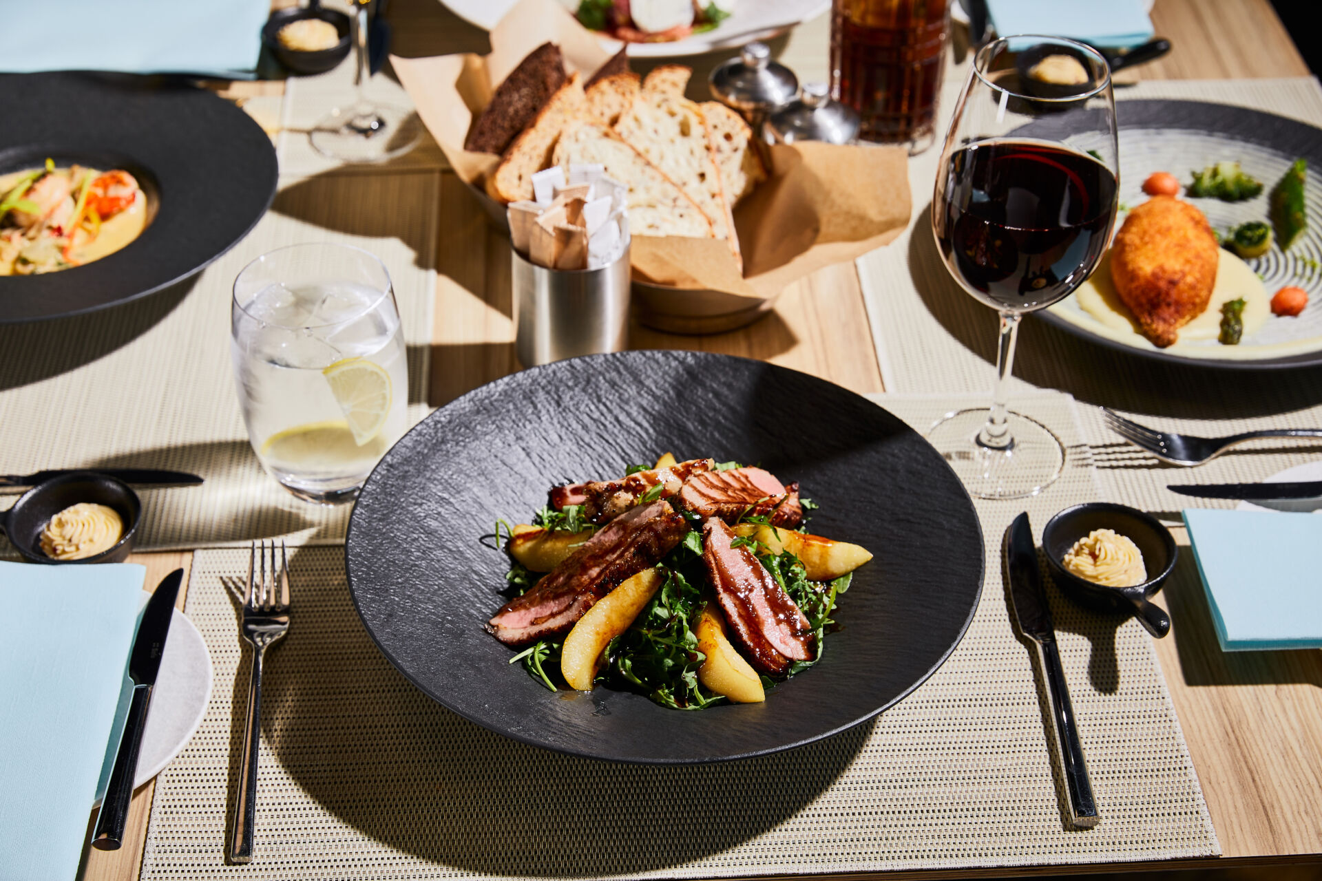 delicious warm salad with meat, arugula, potato served on table in restaurant