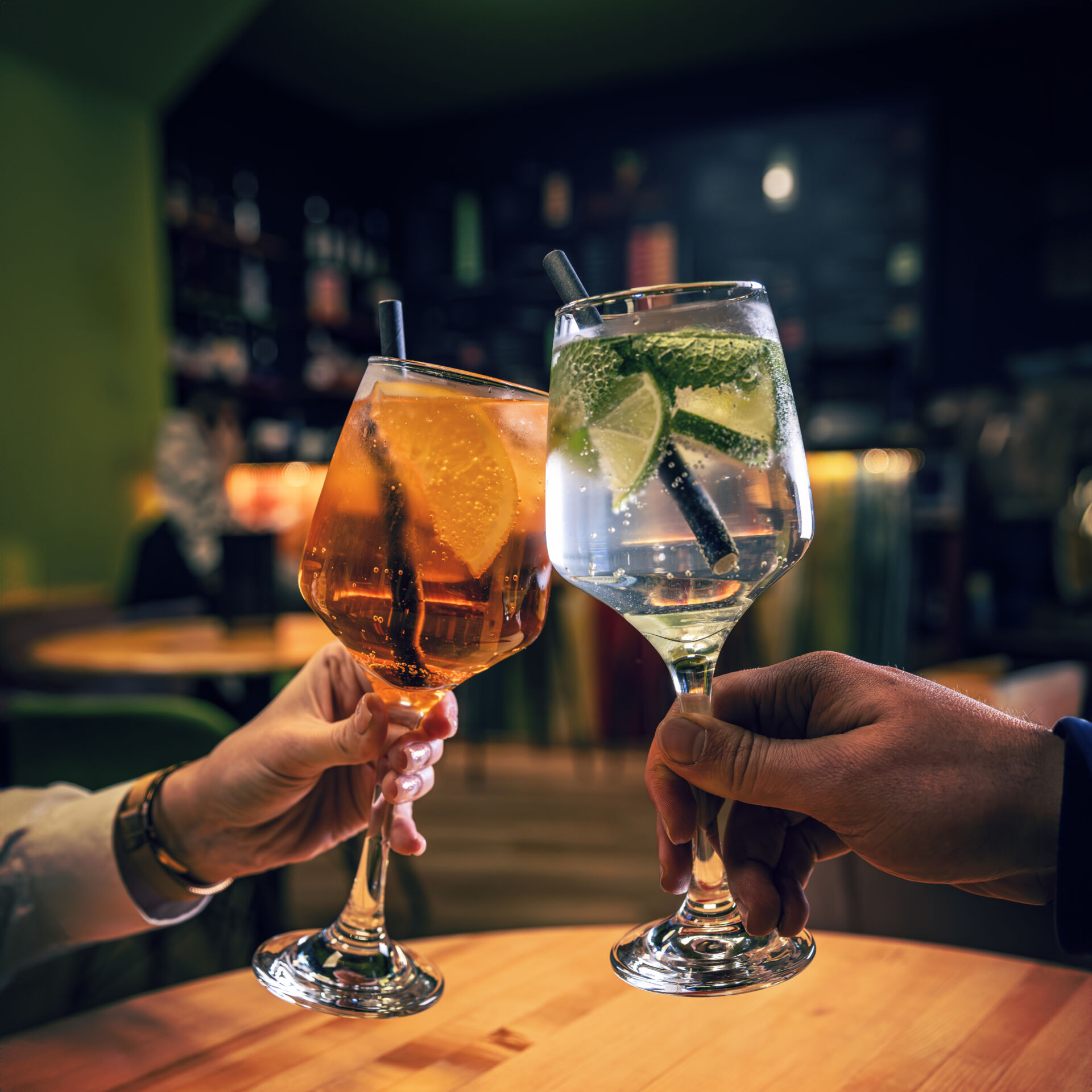 Toast with aperol spritz and gin tonic coctails
