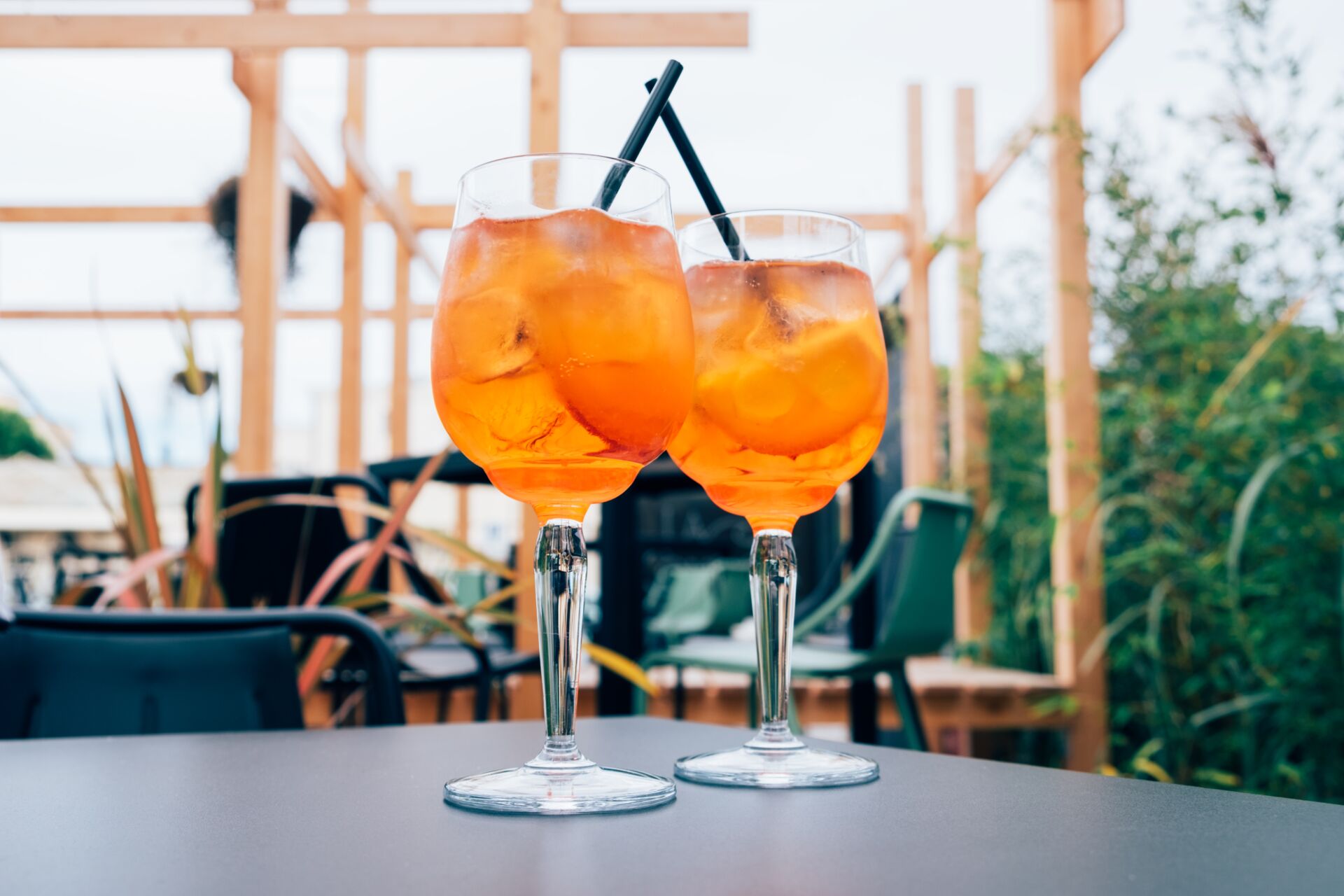 two orange drinks on table outside gastro pub