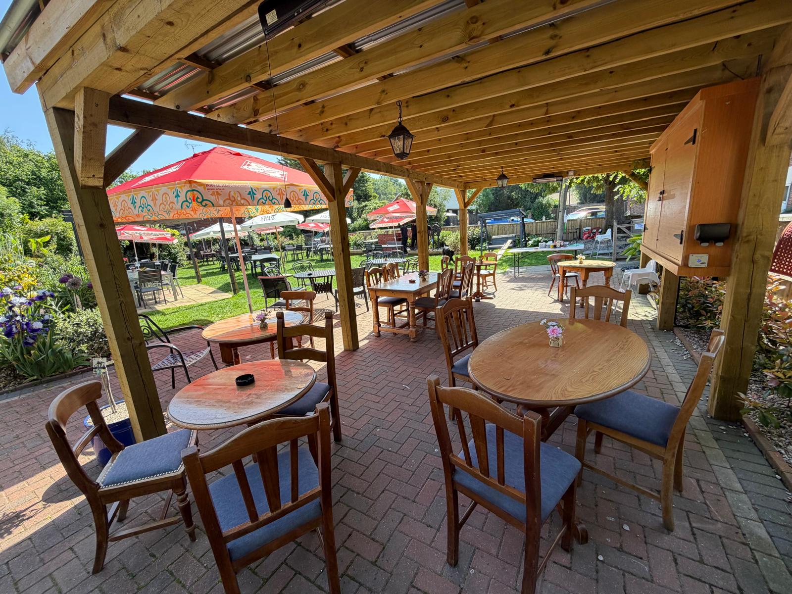 The Red Lion Inn Bridge outside beer garden with pergola, tables and chairs